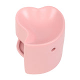 Pink heart-shaped oil burner on a white background