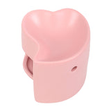 Pink heart-shaped oil burner on a white background