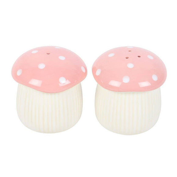 Two mushroom-shaped salt and pepper shakers with pink caps and white stems on a white background.