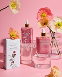 Pink skincare products with floral design on a pink background