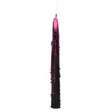 A single black taper candle with dark purple wax dripping down the sides, shown lit against a plain white background.