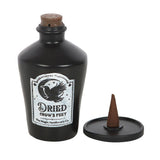 Black bottle labeled 'Dried Crow's Feet' with a cone-shaped incense holder on a white background