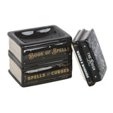 Black and gold decorative box designed like a book titled 'Book of Spells' on a white background