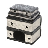 Decorative item resembling a stack of books with star designs on a white background
