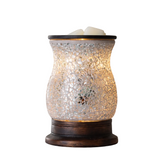 Mosaic-patterned wax warmer on a surface with a blurred background