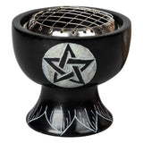 Black metal fire bowl with a star design on a white background