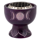Purple ceramic incense burner with silver interior and moon phase design on a white background