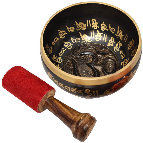 Decorative singing bowl with gold inscriptions and a red mallet on a white background