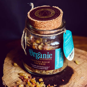 Jar of Organic Goodness incense with a cork lid on a wooden surface