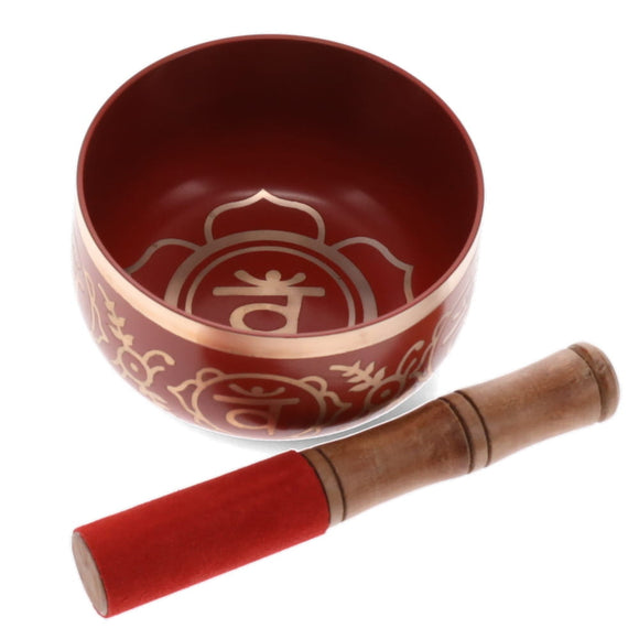 Red singing bowl with decorative patterns and a wooden mallet on a white background