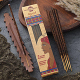 Incense sticks with packaging labeled 'Sacred Elements Myrrh' on a dark surface.