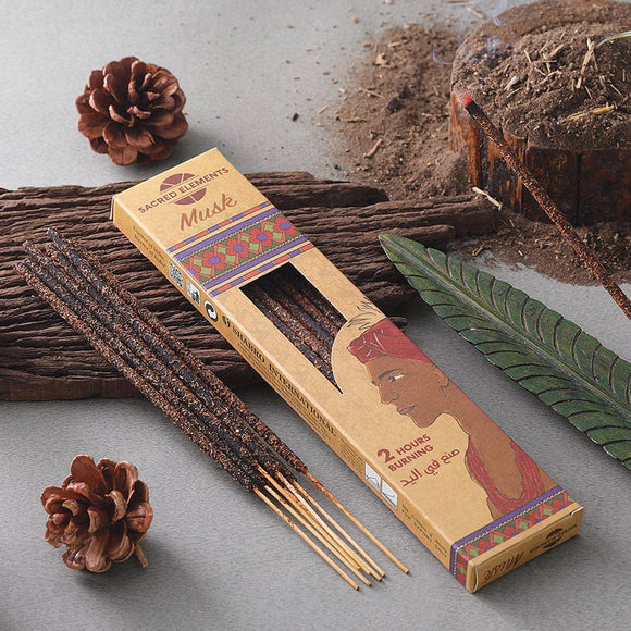 Incense sticks with packaging on a textured surface with natural elements