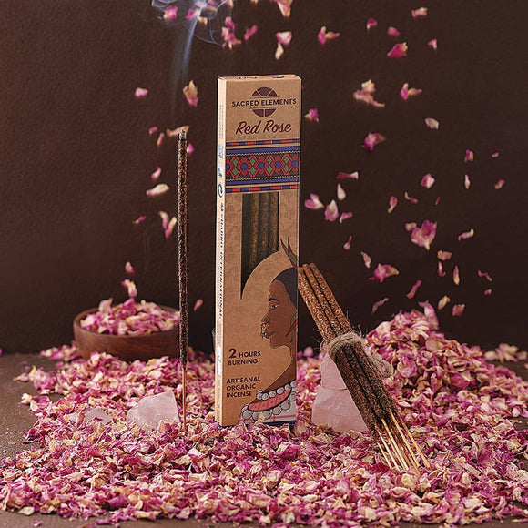 Incense packaging with incense sticks on a dark background with rose petals