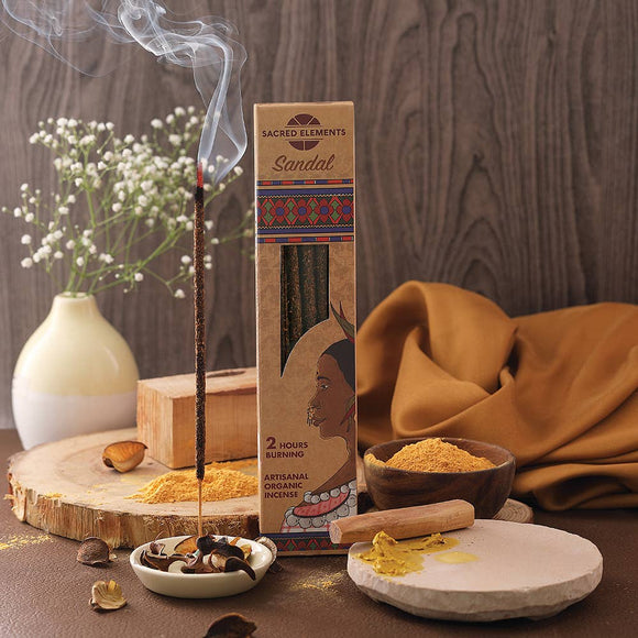 Sandalwood incense with packaging on a wooden surface with decorative elements.