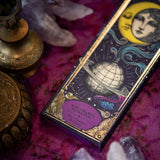 Decorative box with celestial design on a purple fabric background