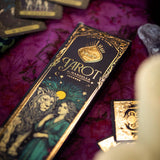 Wilde Tarot deck on a purple fabric background with crystals and cards.