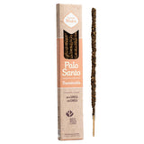 A package of 'Palo Santo' incense sticks by 'Sabor Madre' and 'Reco de la Plata' shown next to a single incense stick standing vertically. The packaging is a tall, narrow cardboard box with a kraft-paper style design and a peach-colored band, while the incense stick is dark brown with a light tan wooden base.