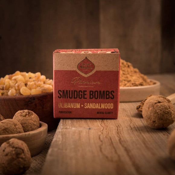 Box of smudge bombs with ingredients on a wooden surface