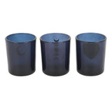 Three blue glass tumblers with moon phase designs on a white background