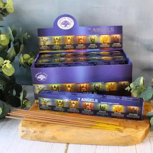 Display of 7 Angels incense sticks with packaging on a wooden board.