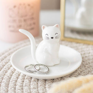 Cat-shaped ring holder with rings on a textured surface