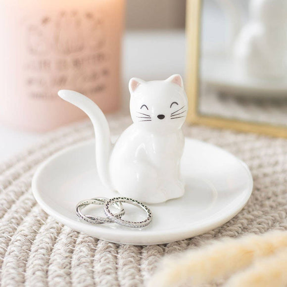 Cat-shaped ring holder with rings on a textured surface