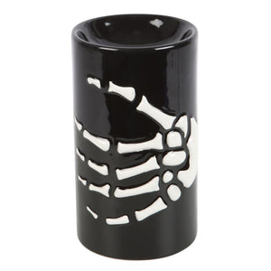 Black ceramic oil burner with skeleton design on a white background