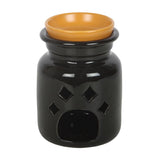 Black wax warmer with an orange bowl on a white background