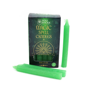 Green spell candles with packaging labeled 'Soul Sticks Magic Spell Candles Success' on a white background.