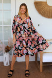 Woman wearing a floral dress in a home setting