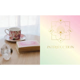 Tea cup and saucer with a deck of cards on a table, next to a card with a design and 'INTRODUCTION' text.