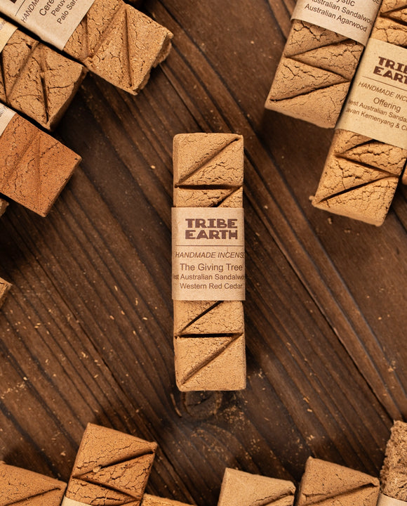 Tribe Earth incense stick packaging on a wooden surface