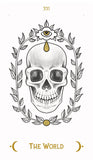 A tarot card illustration reading 'THE WORLD' with the Roman numeral 'XII' at the top. The design shows a detailed grayscale skull centered within a leafy wreath, with a gold eye in a flower at the top and gold text at the bottom on a white background.