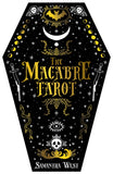 The Macabre Tarot card deck box by Samantha West, designed as a black coffin with gold and white gothic illustrations including a bat, crescent moon, stars, skulls, and swords.