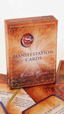 Box of 'Secret' Manifestation Cards by Rhonda Byrne on a wooden surface.