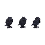 Three black bird figurines on a white background