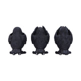 Three black dragon claw figurines on a white background