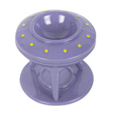 Purple plastic object with yellow dots on a white background