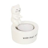 Ceramic cat-shaped holder with a small candle inside on a white background