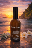 White Sage Smudge Spray bottle on a beach with sunset and flowers
