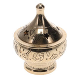 Decorative brass incense burner with star, moon, and hand designs on a white background