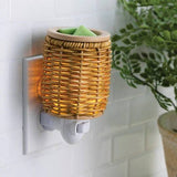 Wicker wall-mounted night light with a plant in the background