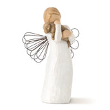 Decorative angel figurine with a child on its shoulders against a white background