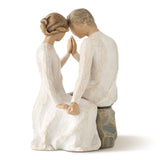 Statue of a couple in a romantic pose on a white background
