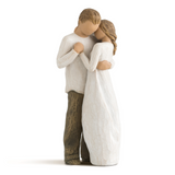 Statue of a couple embracing on a white background