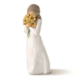 Decorative figurine of a woman holding sunflowers on a white background