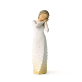 Decorative figurine of a woman in a white dress with gold polka dots on a white background