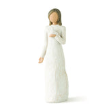 White figurine of a woman in a long dress on a white background