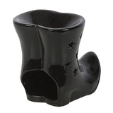 Black ceramic boot-shaped container with star designs on a white background