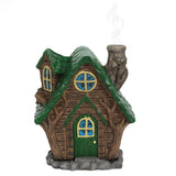 Small decorative house with a green roof and brown body on a white background